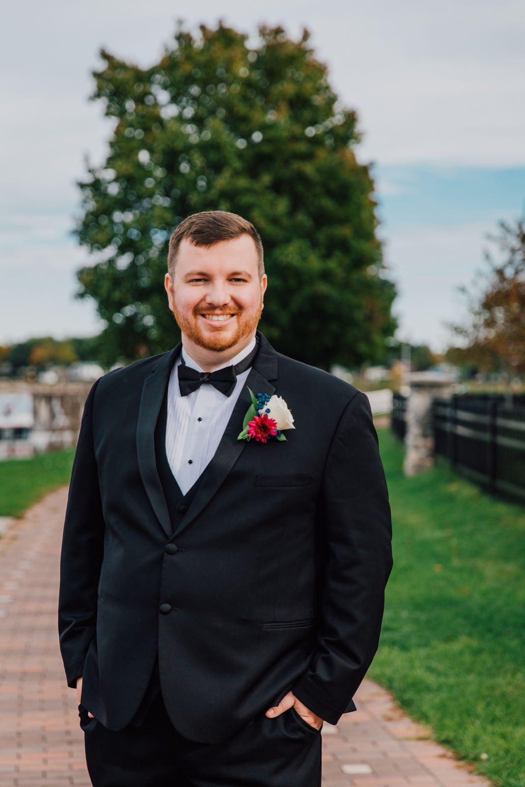  Portrait of a groom in a black tuxedo at 1000 Islands Harbor Hotel wedding 