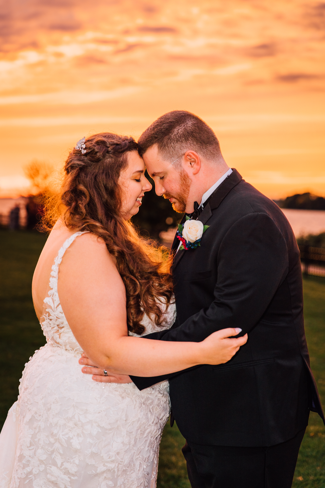  Bride and Groom embrace during sunset wedding photos at 1000 Islands Harbor Hotel 