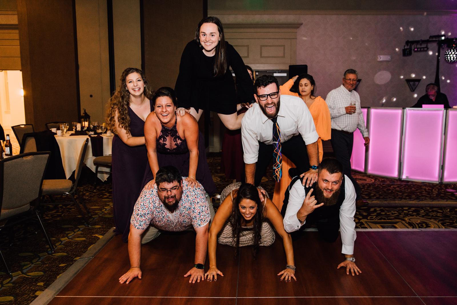 Wedding guests create a human pyramid during 1000 Islands Harbor Hotel wedding reception 