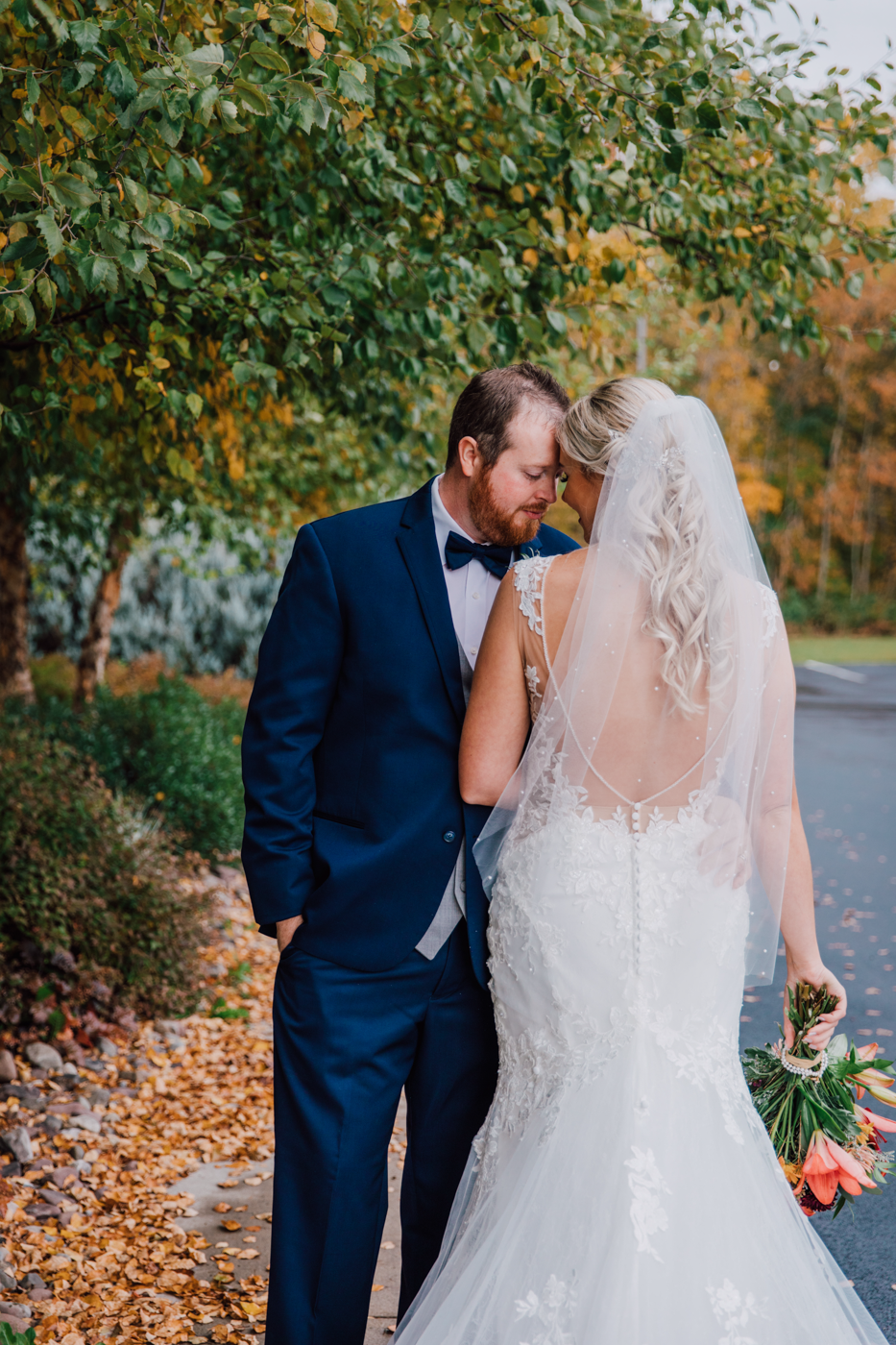  Bride and Groom embrace outside the barn at Tailwater Lodge Altmar 