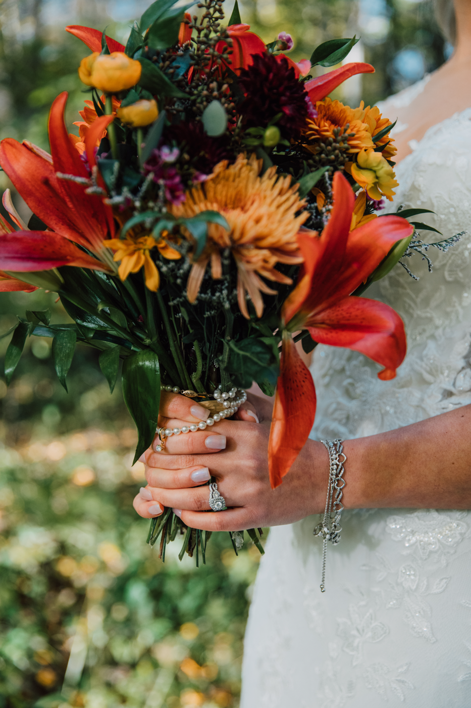  Closeup on a fall bridal bouquet with fall wedding colors and her engagement ring 