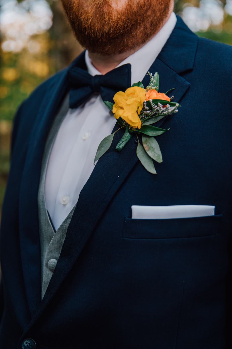  Closeup of the Groom’s tuxedo and boutonniere for fall wedding in central ny 