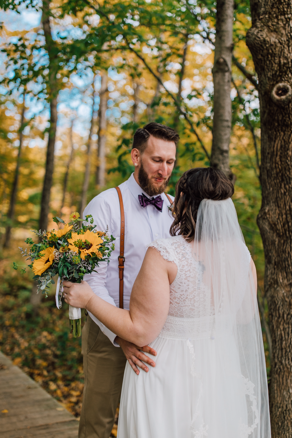  Groom tears up during wedding first look with his Bride in the woods outside Tailwater Lodge 