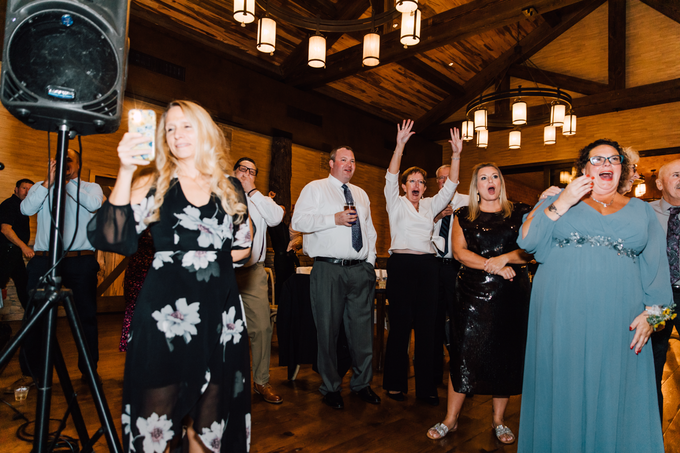  Wedding guests cheer during wedding pregnancy announcement at the reception 