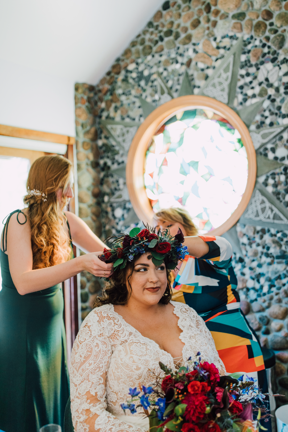  Bride having a floral crowd put on her head before her moody fall wedding in the finger lakes 