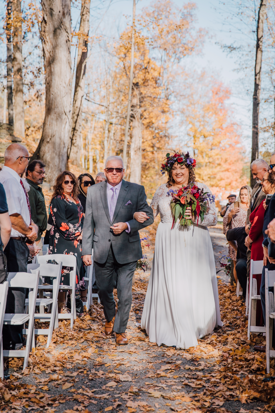  Bride walks down the aisle during her forest wedding in upstate NY 