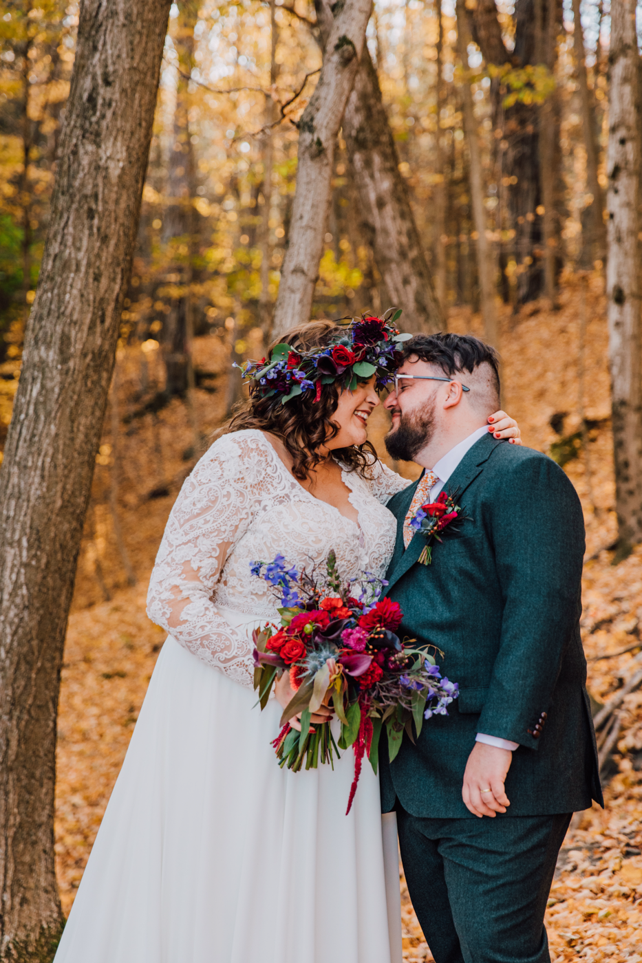  Bride and Groom embrace during forest wedding photos at their fall wedding at New Park Ithaca 