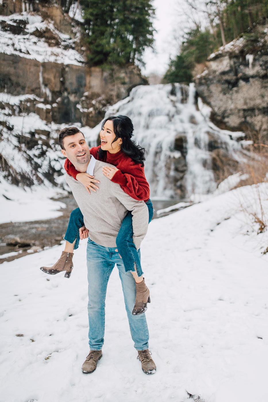  Man giving a piggyback ride to his fiance during a waterfall photoshoot at Delphi Falls 