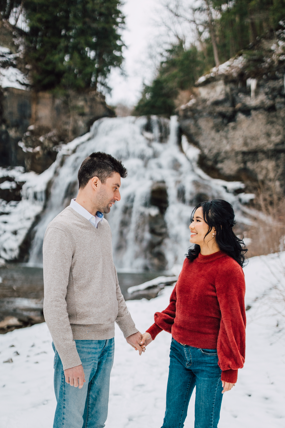  Engaged couple holding hands during winter engagement photos with Brittany Juravich in central NY 