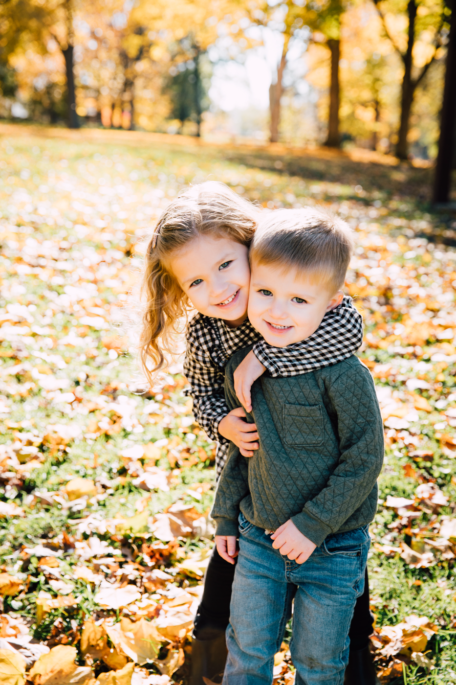  Little girl hugs her brother during fall family photos at Upper Onondaga Park with Brittany Juravich Photography 