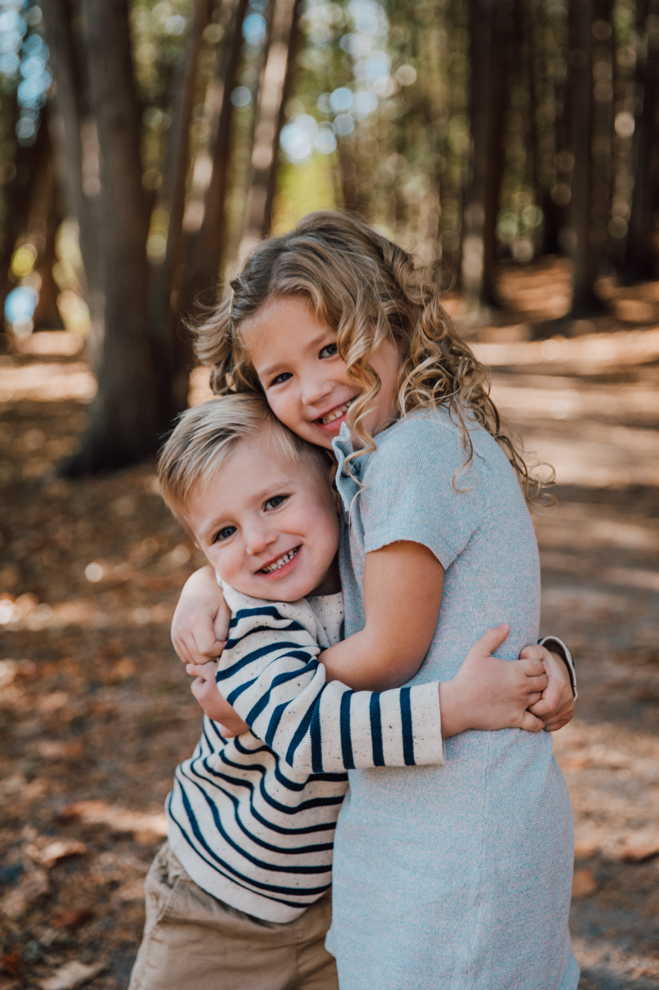  Brother and sister hug during forest family photos at Green Lakes State Park 