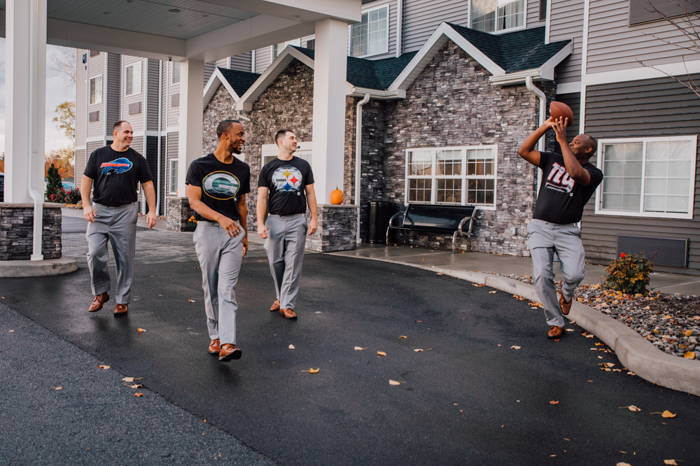  Groomsmen tossing around a football before the wedding begins 