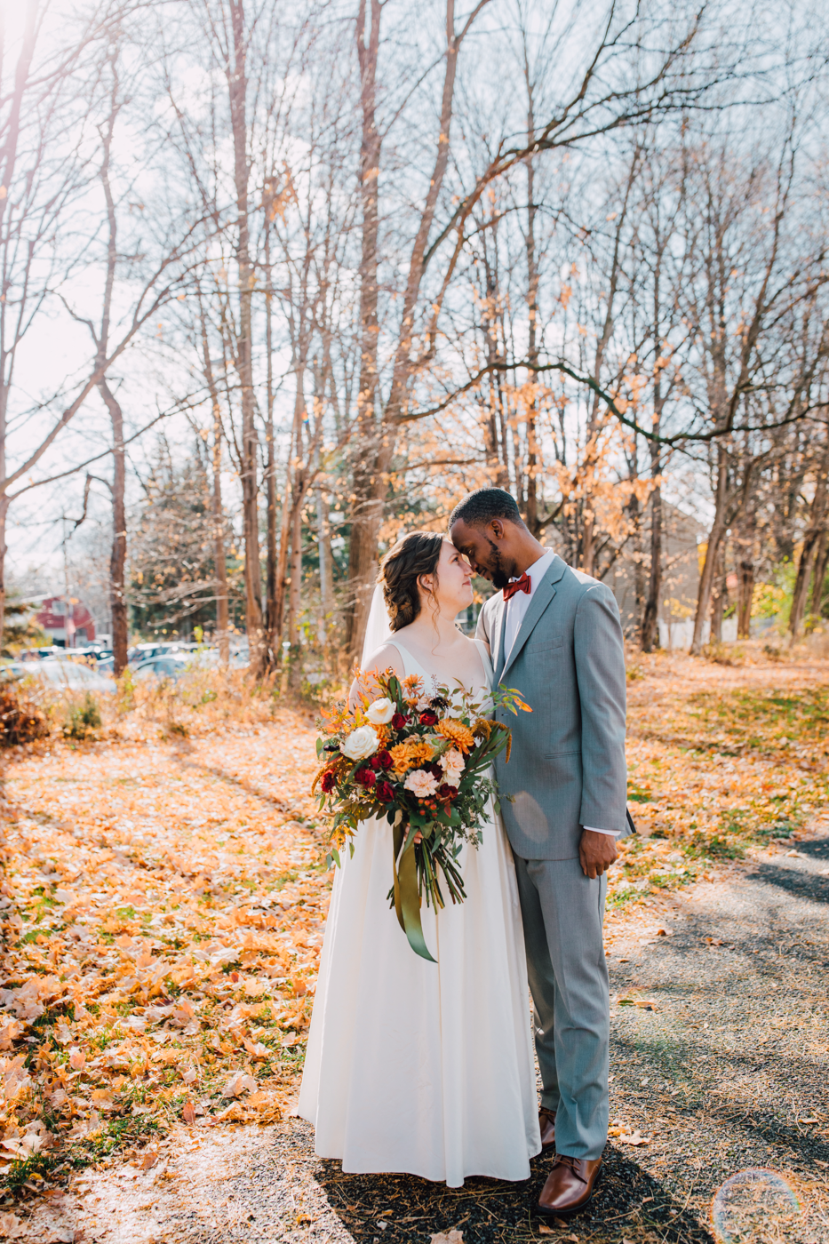  Bride and Groom stand forehead-to-forehead during their fall wedding photos at Westminster Weddings &amp; Events in Mendon, NY 