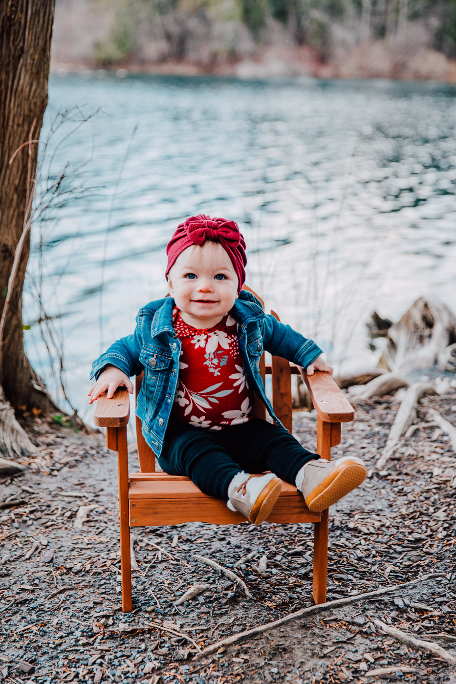  1 year old sits on a chair during a winter photo shoot in Green Lakes State Park 