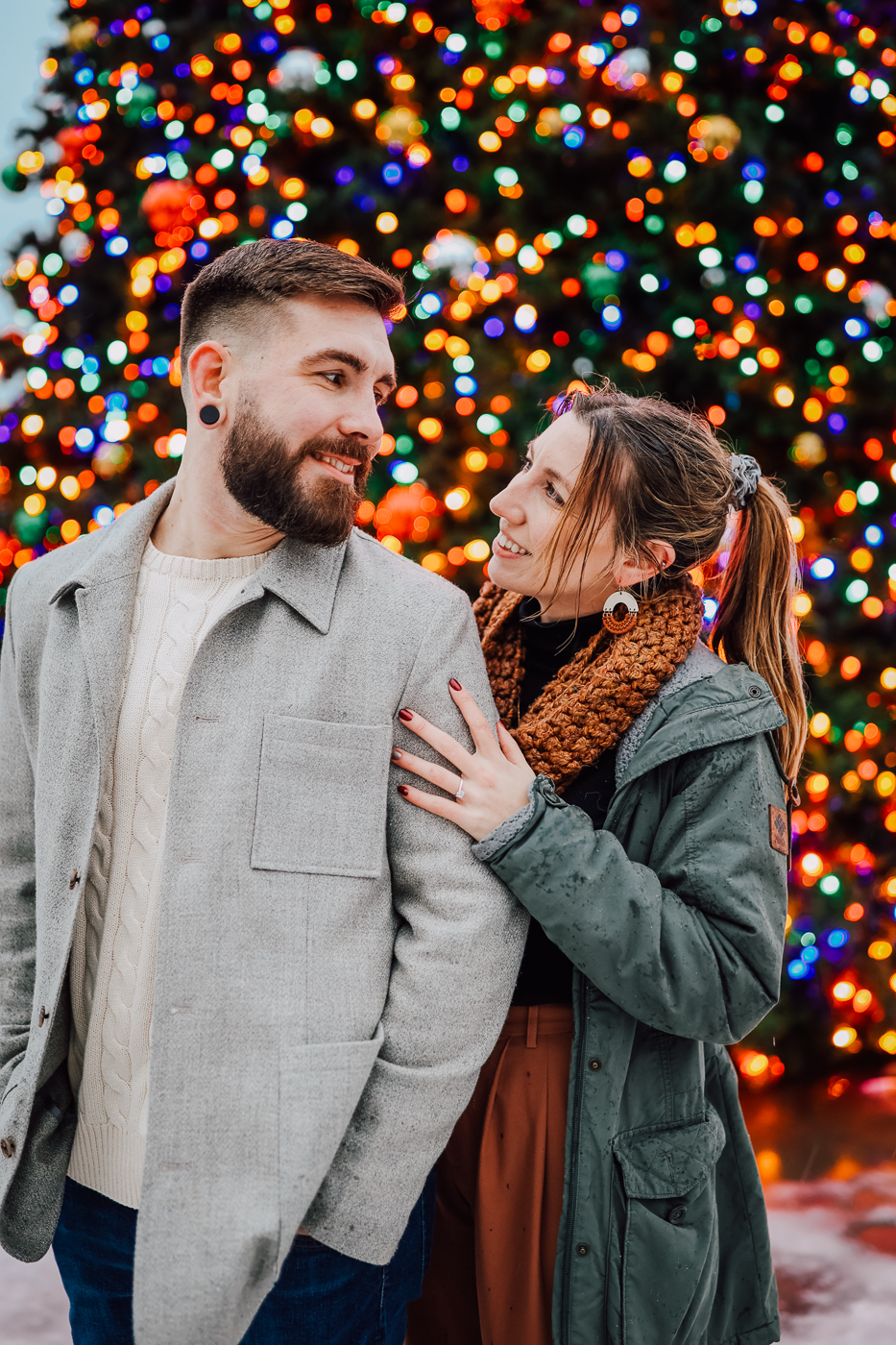 Engaged couple poses in front of a large christmas tree in Clinton Square in downtown Syracuse NY   
