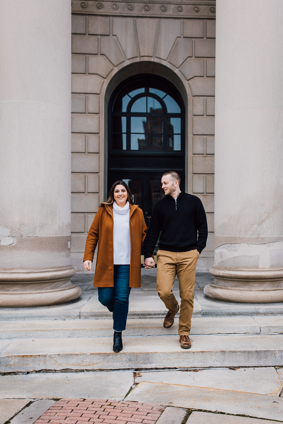  engaged couples walks around downtown Syracuse while doing a winter photo shoot with Brittany Juravich 