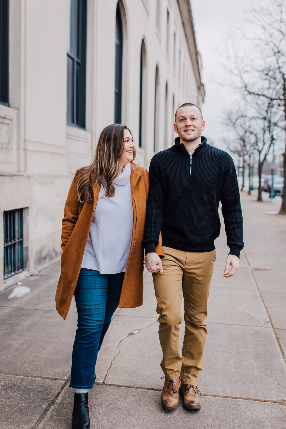  Engaged couple walks through Clinton Square in downtown Syracuse during a winter photo shoot with Briittany Juravich 