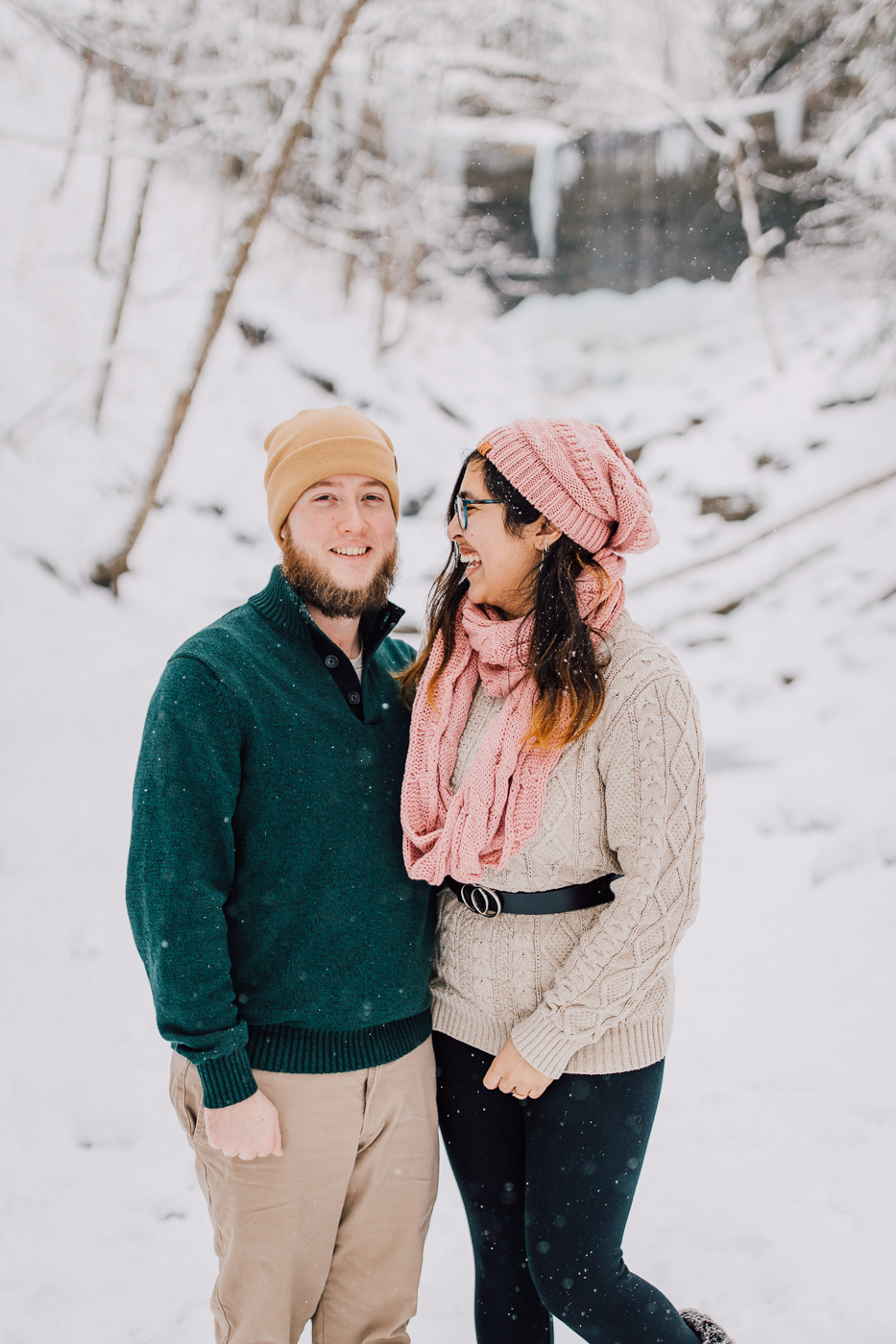  Engaged couple poses for winter wonderland photos at Tinker Falls with Brittany Juravich 