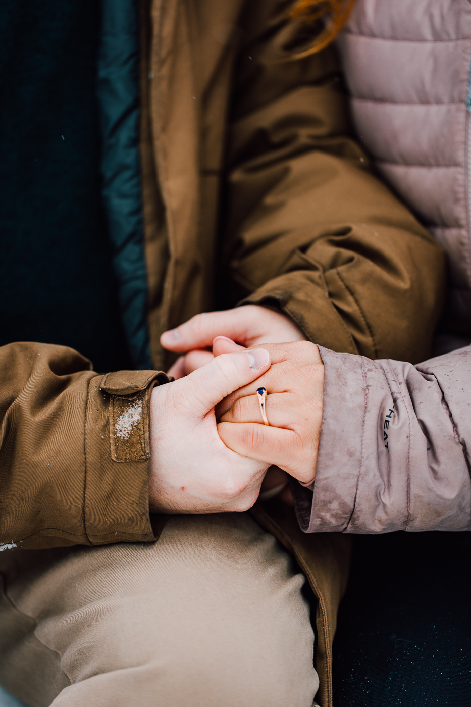  Close up of engaged couples hands and a nontraditional engagement ring during a winter photoshoot in central NY 