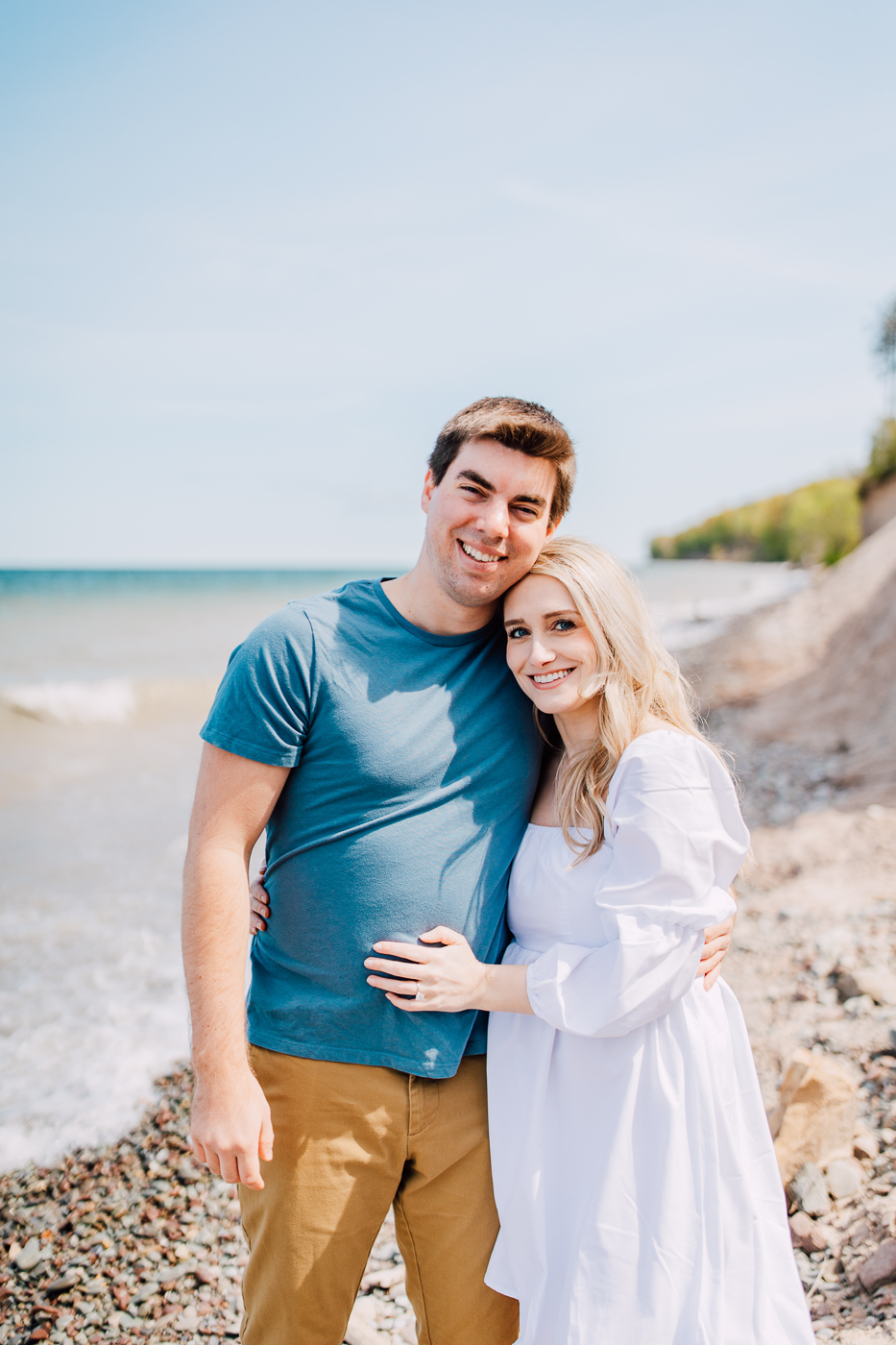  Engaged couple pose for their spring engagement photos at Sterling Bluffs on the shore of Lake Ontario 