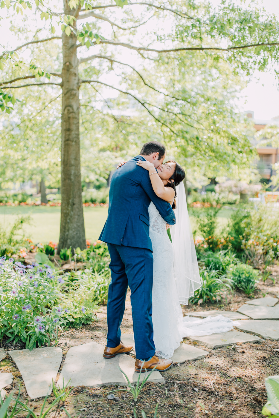  Bride and Groom hug during their first look before their elegant outdoor wedding ceremony in Central NY 