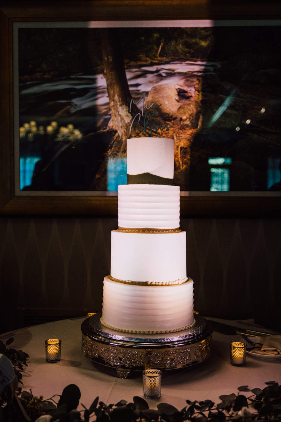  4-tiered wedding cake with clean modern lines and uplighting 