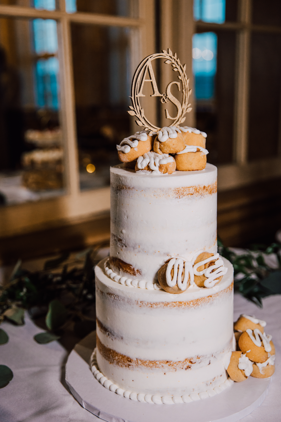  Two-tiered skim coated wedding cake with a wooden cake topper 
