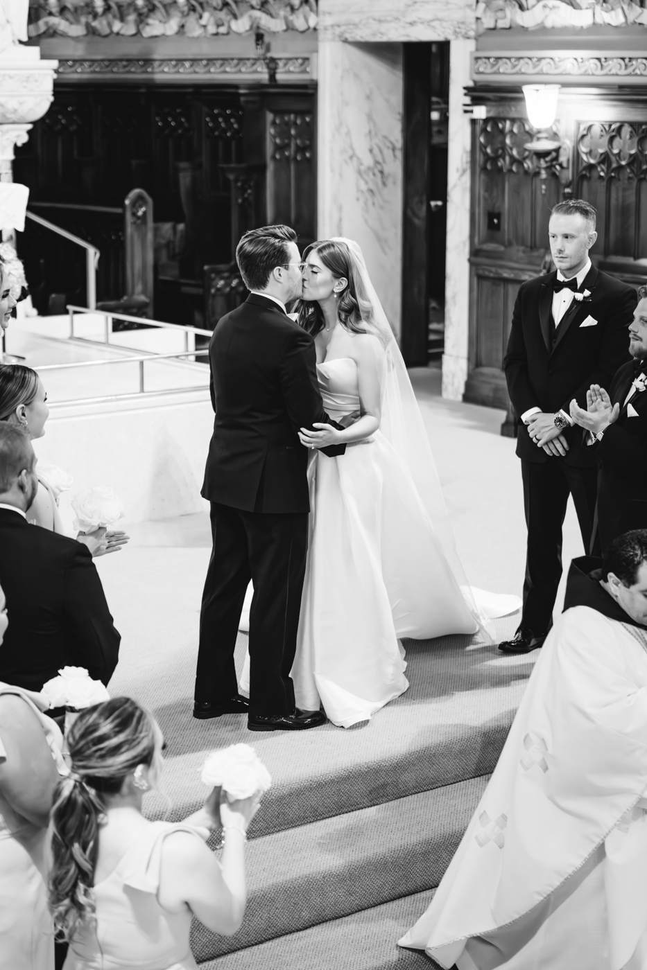  Bride and Groom share a first kiss during their church wedding ceremony on their traditional wedding day in central NY 