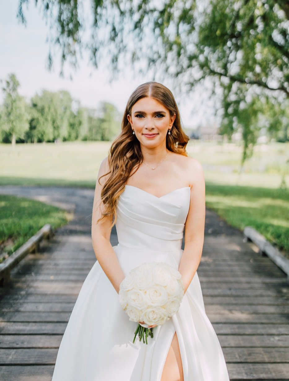  Bride smiles for a portrait by Brittany Juravich during her elegant wedding at Timber Banks 