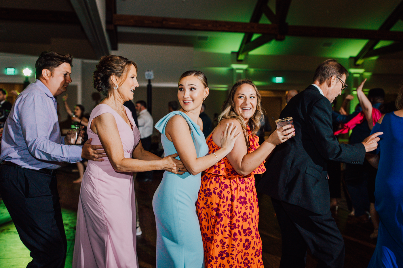  Wedding guests dance in a conga line during a reception at Timber Banks in Baldwinsville NY 
