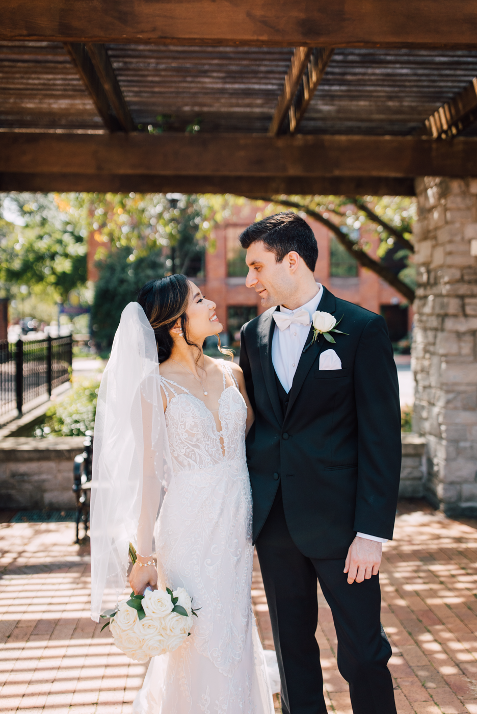  Bride and Groom pose for photos in Franklin Square Park in Downtown Syracuse during their elegant wedding 