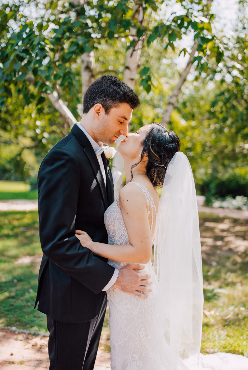  Bride and Groom kiss while taking wedding photos in downtown Syracuse with Brittany Juravich 