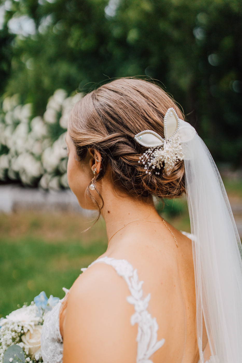  Closeup of Bride’s hair with braids and beaded hair clip and veil 