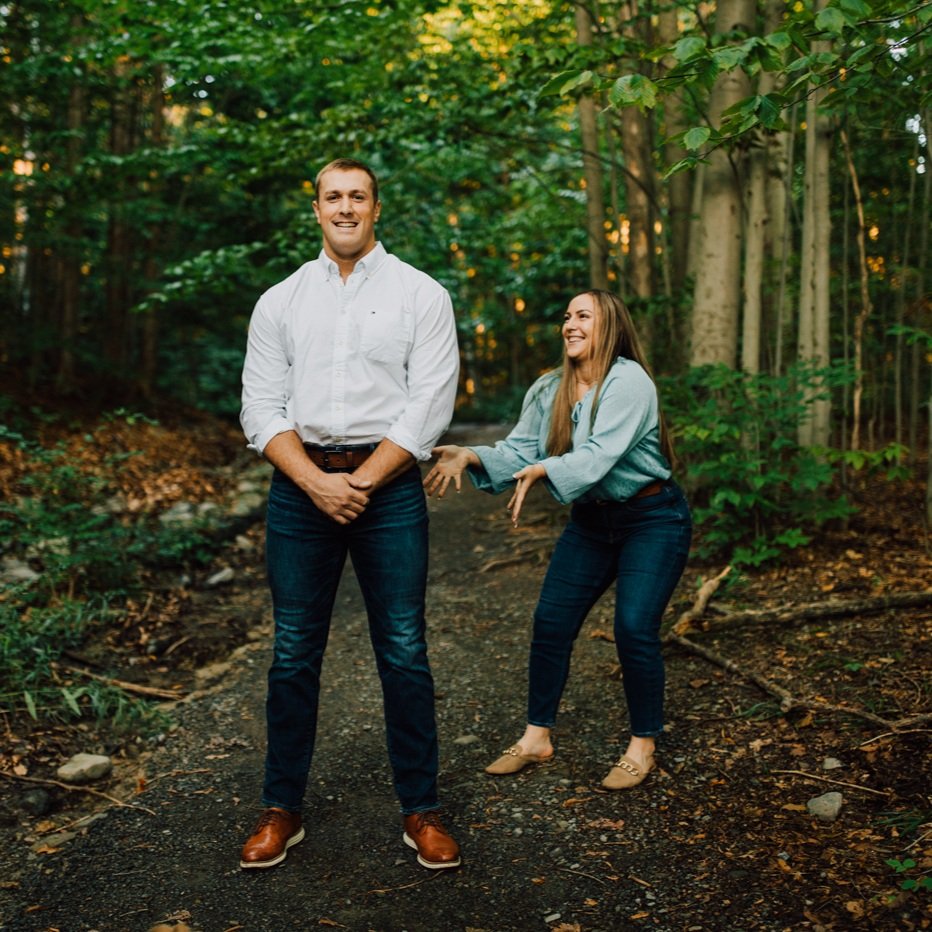  Woman pretends to grab her fiance’s butt during their funny engagement photos at Green Lakes State Park in Central NY 