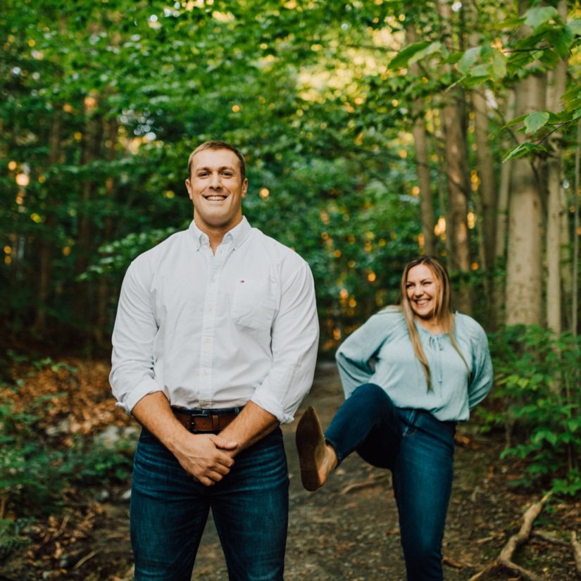  Woman pretends to kick her fiance in the butt during their forest engagement photos at Green Lakes State Park 