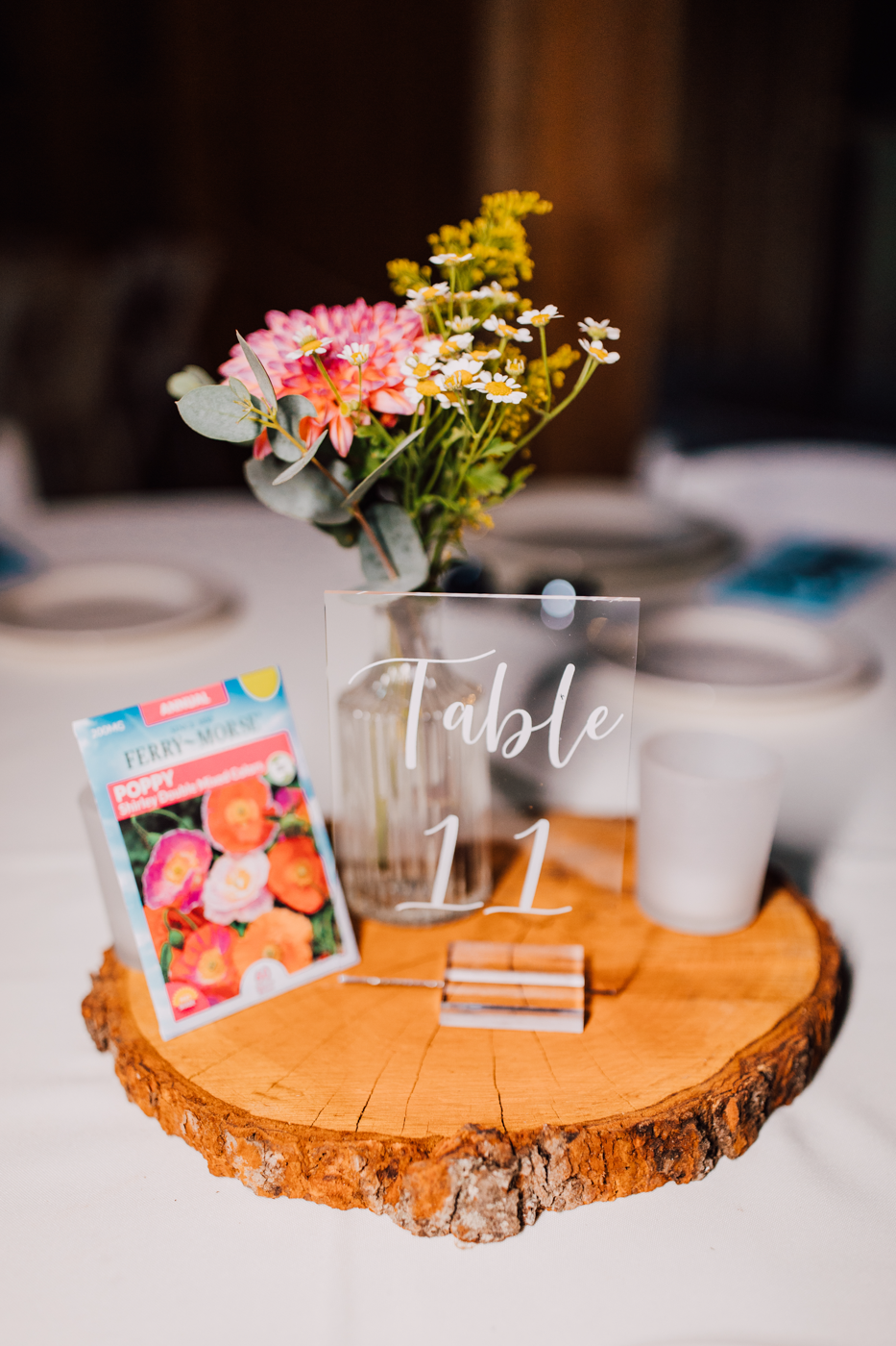  Simple floral centerpieces at a barn wedding with flower seed packets as table names 