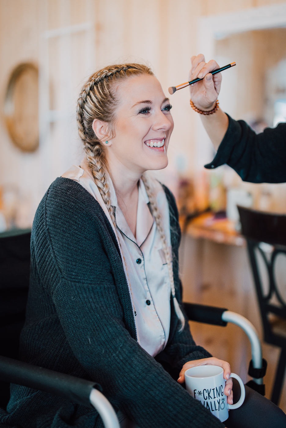  Bride with french braids has her makeup done as she gets ready for her wedding 