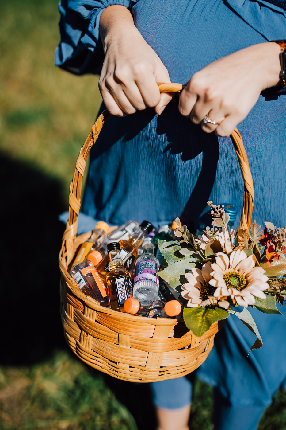  Adult flower girl carries a basket of mini liquor bottles 
