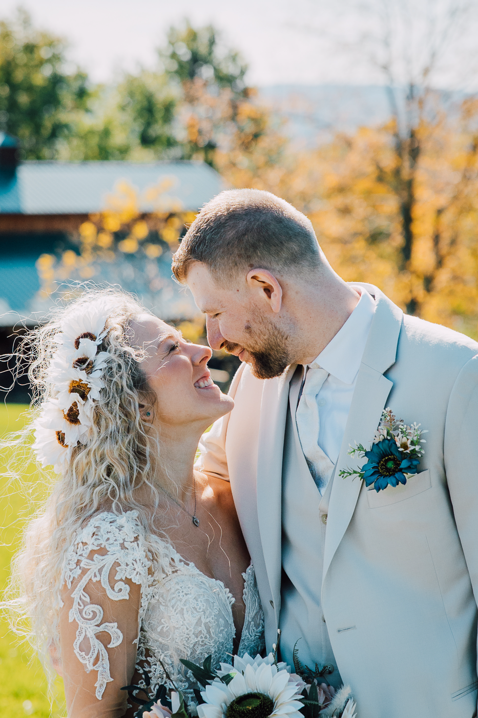  Bride and Groom lean in for a kiss while taking wedding photos in fall at their Paradise Gardens wedding 