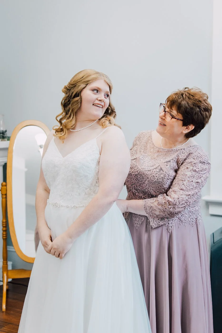  Bride’s mom helps her into her wedding dress before her fall wedding in Central NY 
