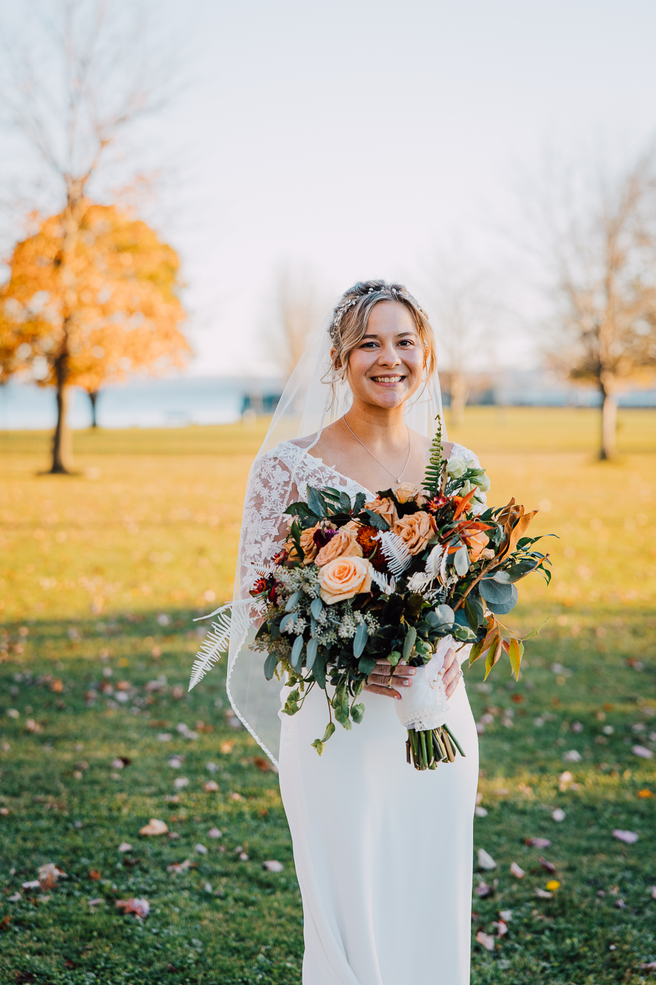  Bride smiles during fall wedding photos at Emerson Park Pavilion 
