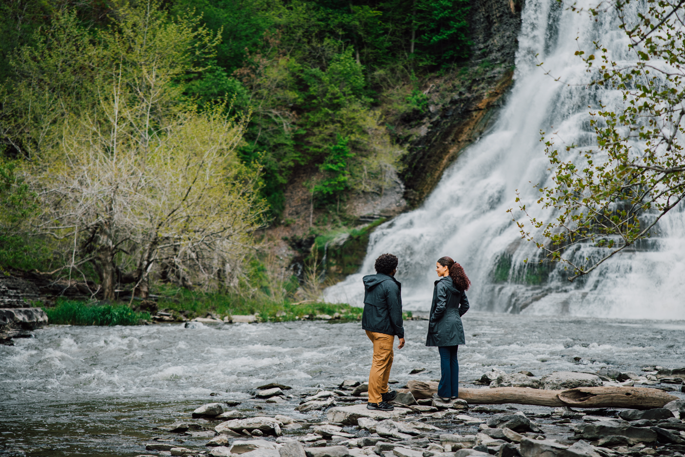 Man and woman overlook Ithaca Falls moments before a surprise proposal