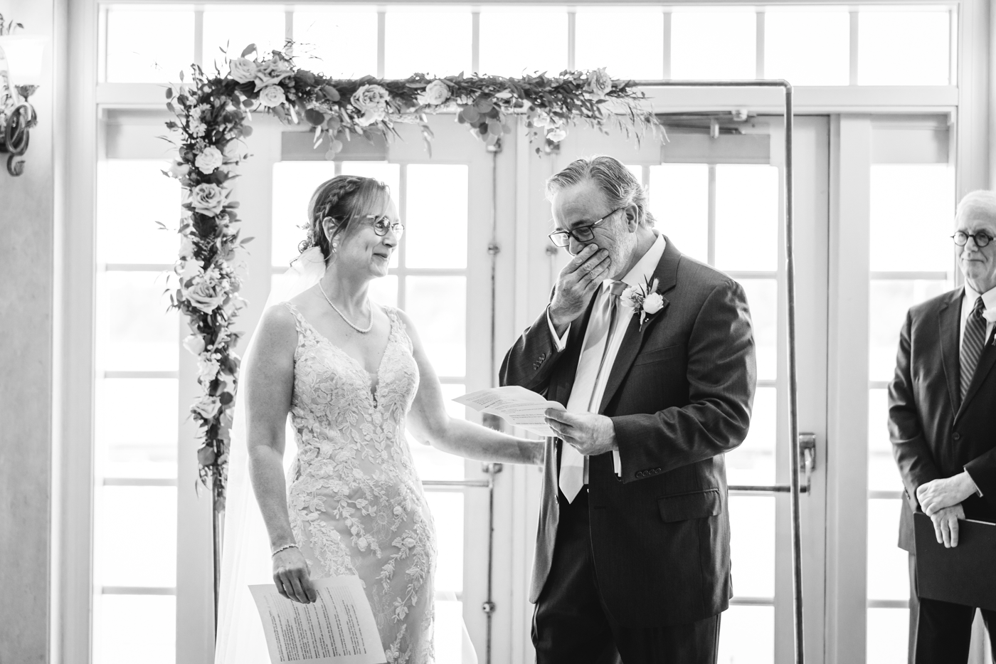 Groom tears up while reading his vows at an intimate wedding at Skaneateles Country Club