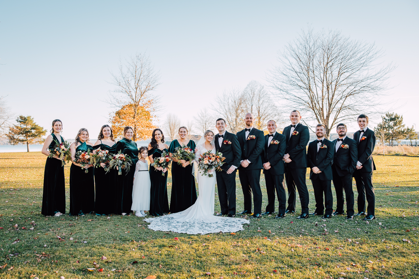 Wedding party poses for sunset wedding photos overlooking the fingerlakes