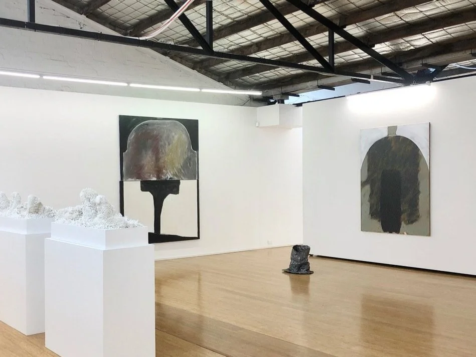 Installation view with Juz Kitson sculpture on left and Lottie Consalvo paintings and lead tree stump containing video work