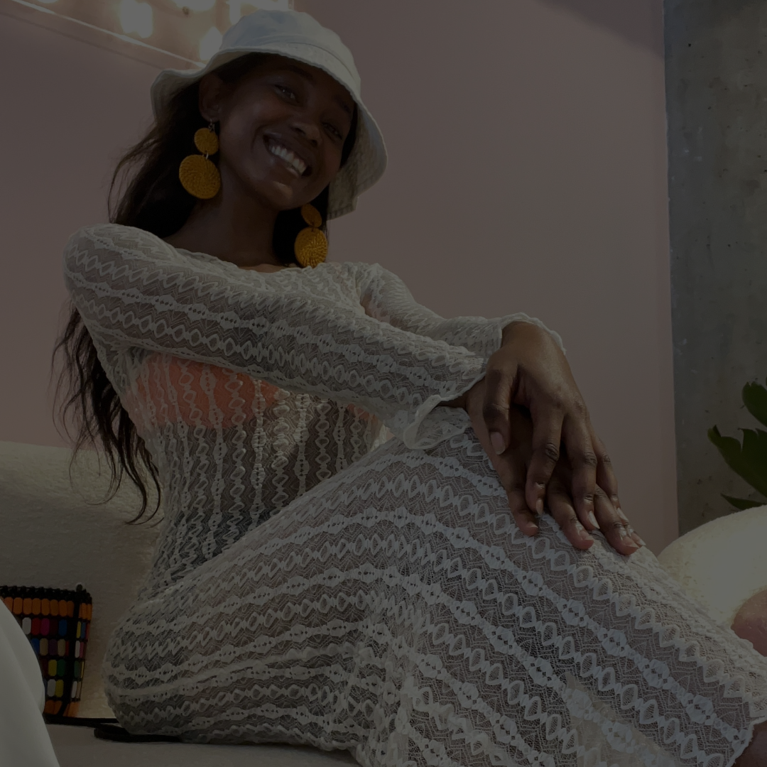 Bridgette in a white lace dress from Mr Price Fashion at the Urban Professionals new product media launch party, smiling with a white bucket hat.