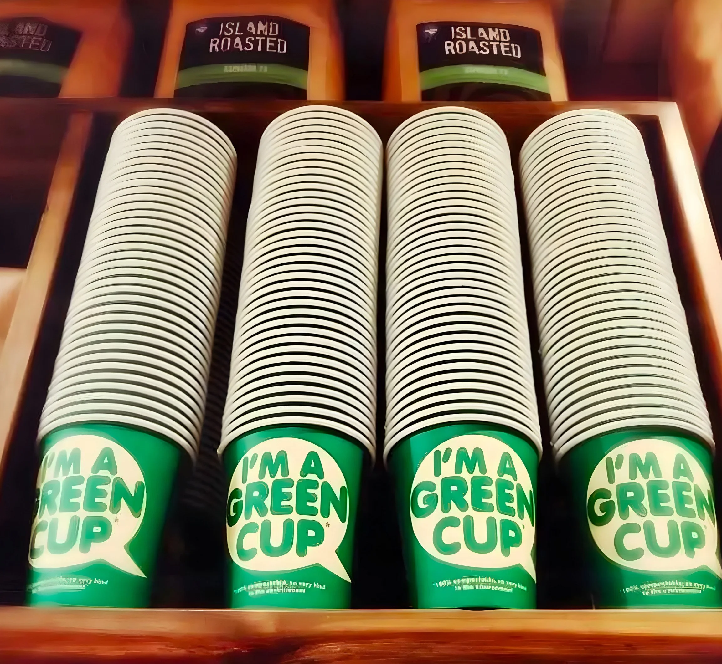 Four rows of green, recyclable cups