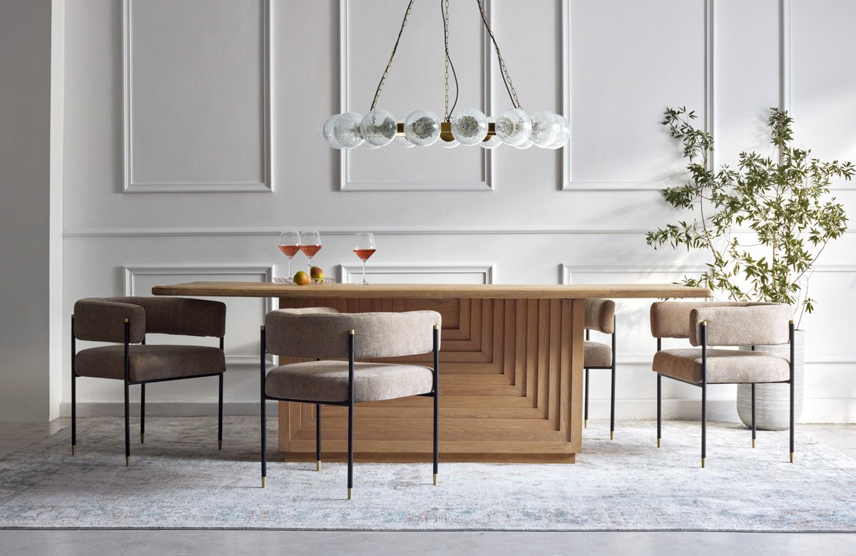 Commercial furniture lookbook shot of a long wooden dining room table with contemporary chairs, by Bakkes.