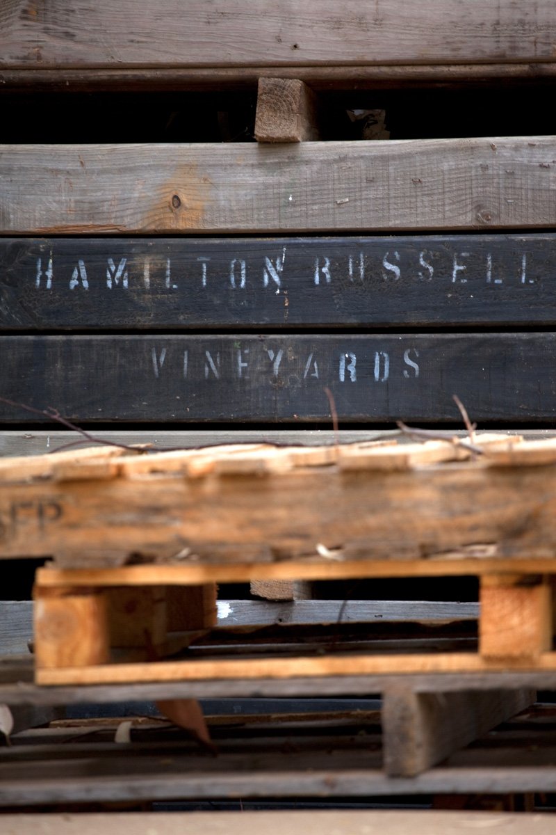 Macro industrial texture shot of branded wooden crates stacked at Hamilton Russell, by Bakkes Images.