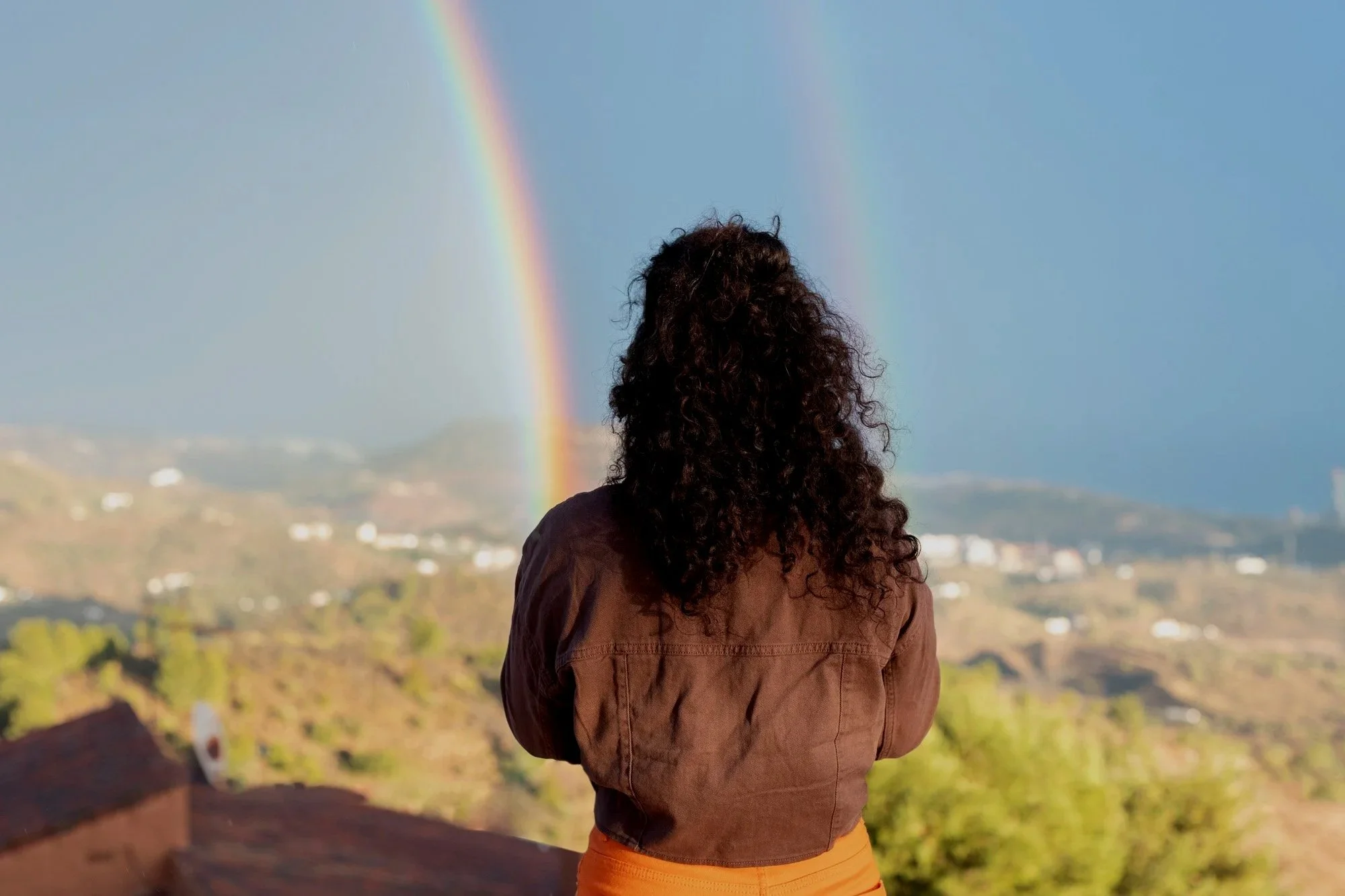 woman-looking-rainbow-outdoor-party.jpg